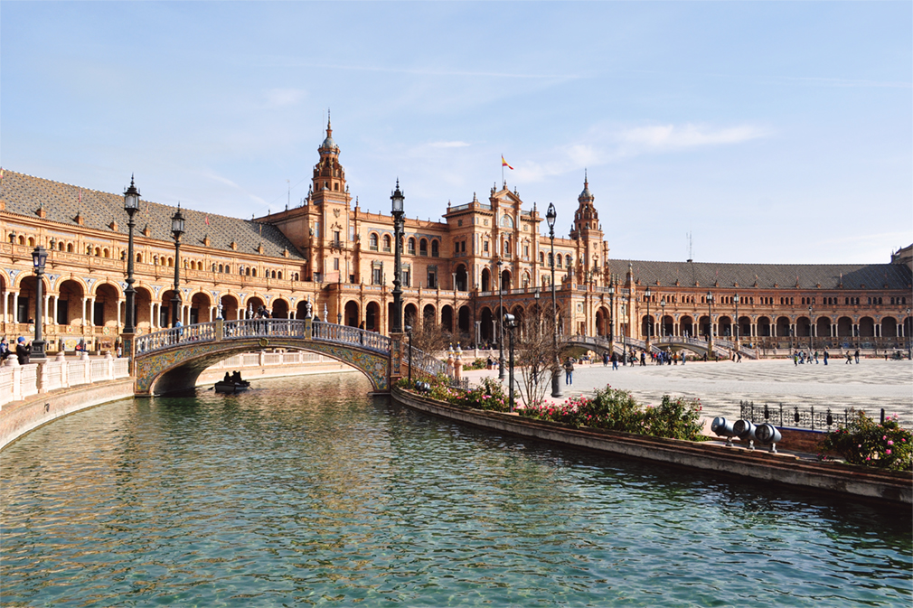 The iconic Spanish architecture of Seville's Plaza de España mixes neo-Mudéjar with neo-Renaissance elements